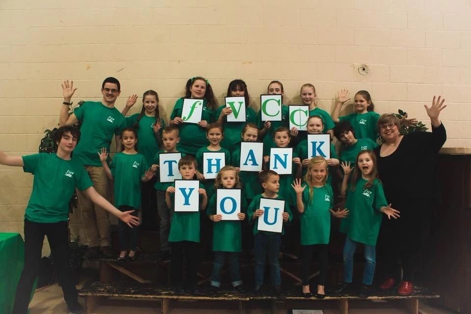 Children holding Thank You signs
